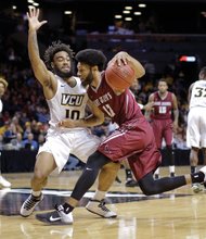 Virginia Commonwealth University guard Jonathan Williams plays smothering defense against St. Joseph’s University’s DeAndre Bembry in the second half of Sunday’s Atlantic 10 Tournament championship game at the Barclays Center in Brooklyn, N.Y. 