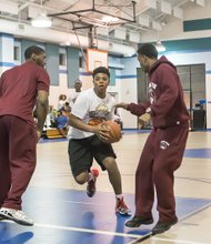 
Scrimmage with VUU Panthers //
Tre’Vaughn Booker, a member of the Broken Men Foundation Youth, splits two Virginia Union University defenders during a recent scrimmage and clinic at the Blackwell Community Center on South Side. VUU Coach Jay Butler and the team also talked to youths about the importance of education. The Chester-based foundation seeks to “guide men back to a path of productivity by providing them with the support network and tools to face their life burdens, heal, and move forward,” according to its website.