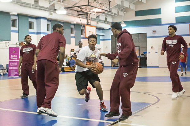 
Scrimmage with VUU Panthers //
Tre’Vaughn Booker, a member of the Broken Men Foundation Youth, splits two Virginia Union University defenders during a recent scrimmage and clinic at the Blackwell Community Center on South Side. VUU Coach Jay Butler and the team also talked to youths about the importance of education. The Chester-based foundation seeks to “guide men back to a path of productivity by providing them with the support network and tools to face their life burdens, heal, and move forward,” according to its website.