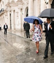 President Obama and First Lady Michelle Obama hold hands Sunday as they walk through the rain to the motorcade after touring Old Havana, Cuba. President Obama, who met with Cuban President Raul Castro and other officials, is the first sitting U.S. president in 88 years to visit the island nation after diplomatic relations were restored on July 20, 2015.
