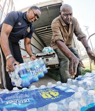 Pitching in for Flint //
Faith and civic groups, businesses and people across the Richmond region are pitching in to help the residents of Flint, Mich., whose public water has been poisoned with high levels of lead. Joining the effort, Fourth Baptist Church Pastor Emory Berry Jr., above left, and Hermon Jones load bottled water onto a truck Wednesday at the East End church to be trucked and distributed to Flint residents. Similar volunteer efforts are being conducted at several churches. Flint’s water crisis began when Michigan officials decided to temporarily switch Flint’s water source from Lake Huron to the Flint River in 2014 as a cost-saving measure. Since then, children and adults have been sickened by the water, with reports of rashes, hair loss and other illnesses.