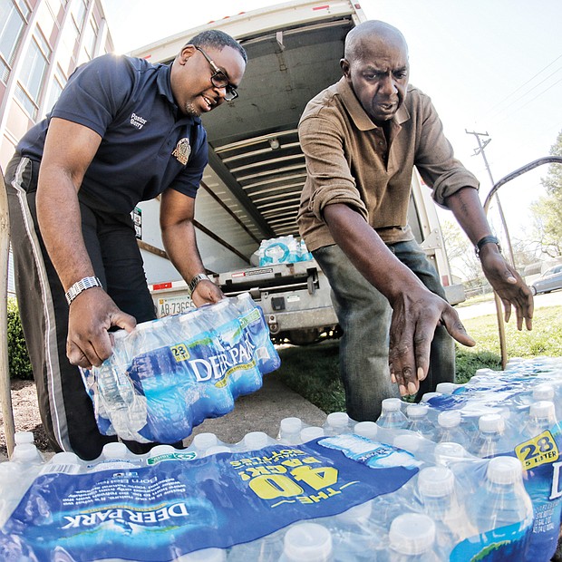 Pitching in for Flint //
Faith and civic groups, businesses and people across the Richmond region are pitching in to help the residents of Flint, Mich., whose public water has been poisoned with high levels of lead. Joining the effort, Fourth Baptist Church Pastor Emory Berry Jr., above left, and Hermon Jones load bottled water onto a truck Wednesday at the East End church to be trucked and distributed to Flint residents. Similar volunteer efforts are being conducted at several churches. Flint’s water crisis began when Michigan officials decided to temporarily switch Flint’s water source from Lake Huron to the Flint River in 2014 as a cost-saving measure. Since then, children and adults have been sickened by the water, with reports of rashes, hair loss and other illnesses.