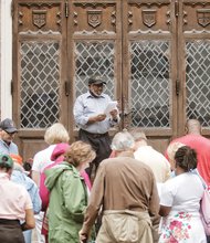 The Rev. Paul A. Coles, pastor of Sharon Baptist Church, leads a reading from the Easter story outside Centenary United Methodist Church on Grace Street, one of the stops on the Stations of the Cross walk last Friday.
