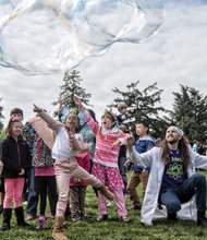 Easter events in the city // Aaris Moore, 5, center, and other wide-eyed children reach up to try and touch a giant bubble last Saturday at Maymont’s Dominion Family Easter celebration. The family friendly event featured an Easter egg hunt, bonnet making and parade and storytelling. 