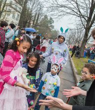 Easter Events In the City // dressed in colorful holiday outfits, from left, Heaven Johnson, 9, Precious Johnson, 6, Javien Tineo, 5, and Jaiden Taveras, 9, keep a close eye on what lands in Heaven’s hands as a magician performs a trick. People and pets alike donned bonnets and costumes to enjoy the day.