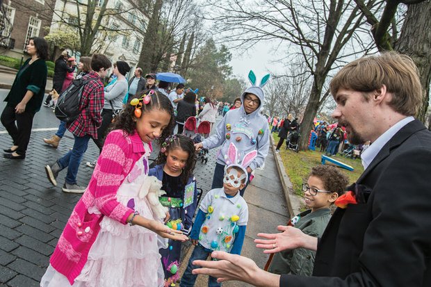 Easter Events In the City // dressed in colorful holiday outfits, from left, Heaven Johnson, 9, Precious Johnson, 6, Javien Tineo, 5, and Jaiden Taveras, 9, keep a close eye on what lands in Heaven’s hands as a magician performs a trick. People and pets alike donned bonnets and costumes to enjoy the day.