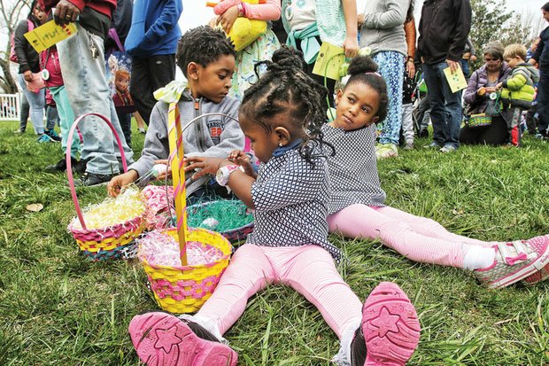 Easter egg-citement // The Cockrell siblings, Victoria, 2, front, Jermiah, 5, and Moriah, 4, rest in the grass with their Easter baskets Saturday at Maymont’s Dominion Family Easter. Hundreds of people of all ages enjoyed a variety of activities at the park in Richmond’s West End during the annual event. 