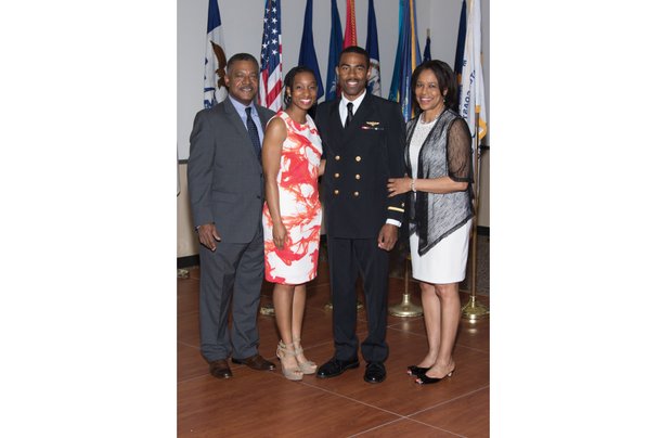 Ensign Justin Roberts of Richmond, second from right, is joined by his family after receiving his wings at a recent ceremony in Texas. From left, his father, Roscoe Roberts, wife 2nd Lt. Jazmind Roberts, and mother Judge Angela Roberts.