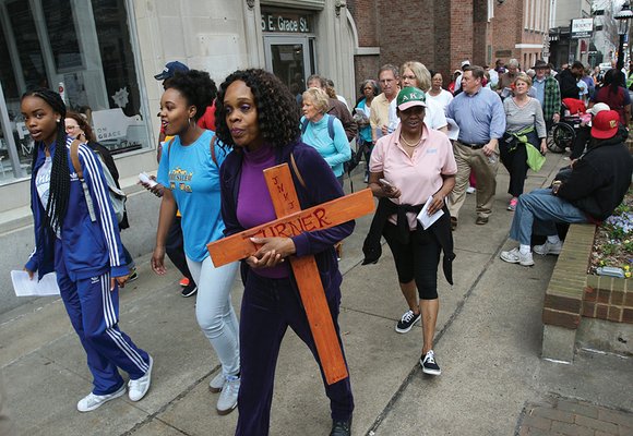 Evangelist Michelle Turner of All Saints Episcopal Church in Henrico County held a wooden cross that she made as she ...