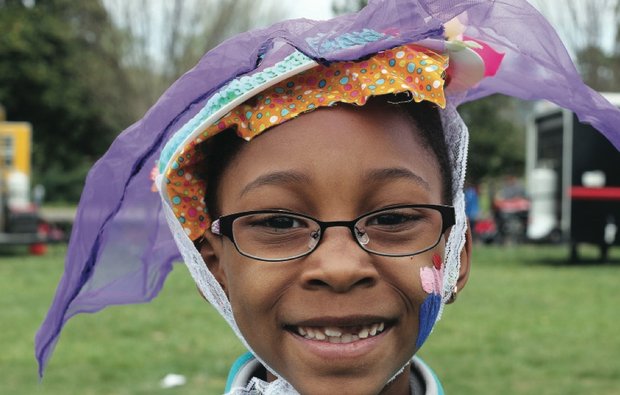 Easter events in the city //Destini Spain shows off the colorful bonnet she crafted alongside scores of other youngsters.