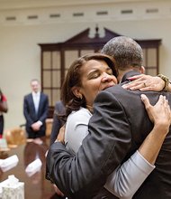 Kemba Smith, a former Henrico resident, hugs President Obama during a meeting March 30 in the Roosevelt Room of the White House with former federal prison inmates whose sentences have been commuted.