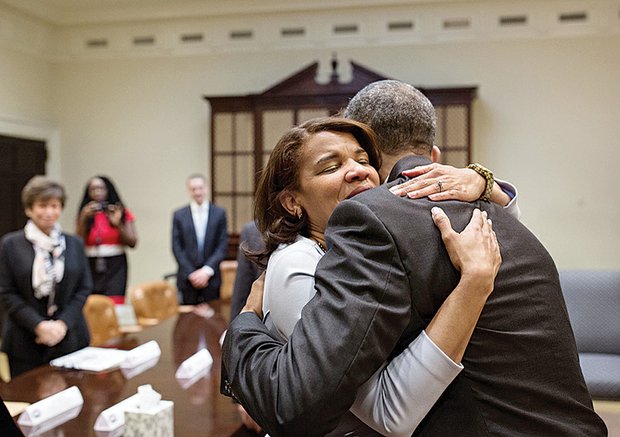 Kemba Smith, a former Henrico resident, hugs President Obama during a meeting March 30 in the Roosevelt Room of the White House with former federal prison inmates whose sentences have been commuted.