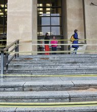 
Yellow tape now blocks the granite steps leading into the Richmond Public Library’s Main Branch in Downtown. Over the years, winter’s cold has cracked the steps, making them dangerous, according to Clay Dishon, interim library director. The city Department of Public Works is planning needed repairs so patrons can once again use the stairway at 101 E. Franklin St.