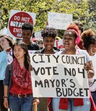 Open High School students march toward City Hall Monday after a walkout in which they called for more money for city schools.