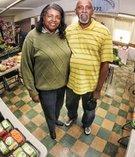 Betty and John Thombs display the fresh vegetables and fruits they collected from area stores on Tuesday. The food is given away in the social hall at Zion Baptist Church, 20th and Decatur streets, on South Side. The hunger-fighting couple has been quietly creating this pop-up food-giveaway stand daily for more than five years.   