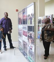 Focusing on campus life // The works of Virginia Union University’s official photographer, Ayasha Sledge, are featured in an exhibit, “Behind the Lens,” focusing on campus life at the historic Lombardy Street institution. Among those enjoying the recent exhibit are the Rev. Larry Enis and his daughter, Jocelyn, below left, and Barbara Sayles, right. The free exhibit is open to the public through Monday, May 9, at the Claude G. Perkins Living and Learning Center on the VUU campus.