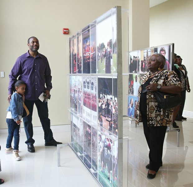 Focusing on campus life // The works of Virginia Union University’s official photographer, Ayasha Sledge, are featured in an exhibit, “Behind the Lens,” focusing on campus life at the historic Lombardy Street institution. Among those enjoying the recent exhibit are the Rev. Larry Enis and his daughter, Jocelyn, below left, and Barbara Sayles, right. The free exhibit is open to the public through Monday, May 9, at the Claude G. Perkins Living and Learning Center on the VUU campus.