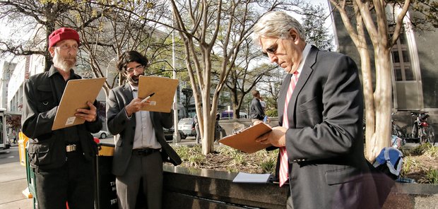 This is becoming a familiar sight across Richmond — candidates for public office collecting signatures from registered voters on petitions. Here, three mayoral candidates help each other by signing each other’s petitions Monday outside City Hall. From left, they are activist Alan Schintzius, teacher Chad Ingold and architect Bruce Tyler. To get on the ballot, each must collect 500 signatures, with at least 50 from each of the city’s nine City Council districts. 