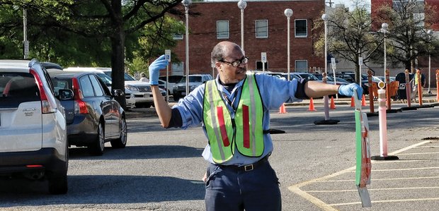 U.S. Postal Service employee Louis Hatcher directs traffic at the Main Post Office on Brook Road as last-minute filers arrive Monday to drop off their federal income tax documents before the deadline. The goal: To have their letters and envelopes postmarked April 18 to avoid penalties for late filing. The deadline is usually April 15, but it was extended this year because of Washington’s annual D.C. Emancipation Day holiday commemorating President Abraham Lincoln’s signing of a law on April 16, 1862, abolishing slavery in the nation’s capital. Although the holiday is recognized only in the District of Columbia, the IRS recognizes the day as a legal holiday and extends tax filing until the next business day when it falls on a Friday or during a weekend.