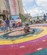 
Coloring the universe //
Dominique Vick, center, carefully paints a mandala last Saturday at the 7th Annual RVA Earth Day Festival in Manchester. A mandala is a spiritual and ritual symbol in Indian religions representing the universe and most often is a square with four gates containing a circle with a center point. It was one of several family friendly activities at the event in South Side designed to promote environmental awareness.