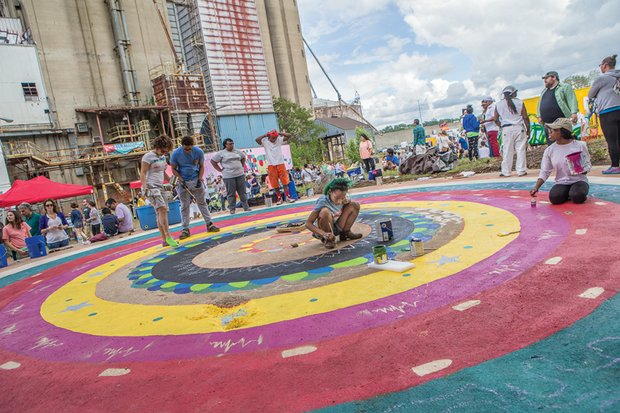 
Coloring the universe //
Dominique Vick, center, carefully paints a mandala last Saturday at the 7th Annual RVA Earth Day Festival in Manchester. A mandala is a spiritual and ritual symbol in Indian religions representing the universe and most often is a square with four gates containing a circle with a center point. It was one of several family friendly activities at the event in South Side designed to promote environmental awareness.