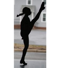 Morgan Bullock, seen in silhouette, practices one of the intricate and athletic Irish dance moves. Location: Baffa Academy of Irish Dance in Chesterfield County.