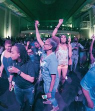 Prince fans party like it’s 1999 under purple lights at a pop-up party Tuesday at the Hippodrome Theatre in Jackson Ward. 