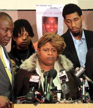 Samaria Rice, center, the mother of 12-year-old Tamir Rice, speaks during a December 2014 news conference about her son, who was shot and killed by Cleveland police while playing in a park. With Mrs. Rice are attorney Benjamin Crump, left; Tamir’s father, Leonard Warner, second from right; and attorney Walter Madison, right.