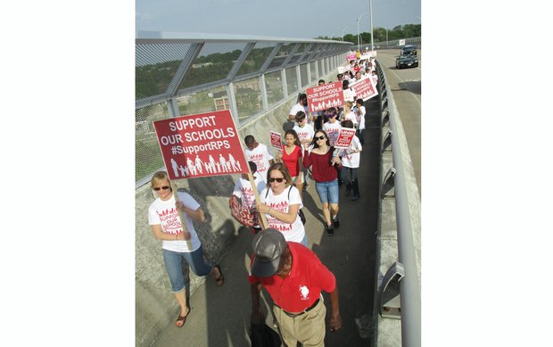 
Marchers cross the Martin Luther King Jr. Memorial Bridge on Monday en route to a rally outside Richmond City Hall seeking more money for Richmond Public Schools.