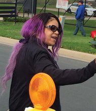 
Prince’s sister, Tyka Nelson, holds out a rose to mourners who gathered outside Paisley Park last Thursday to remember the iconic entertainer who died earlier in the day.