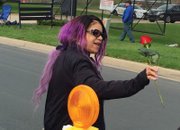 
Prince’s sister, Tyka Nelson, holds out a rose to mourners who gathered outside Paisley Park last Thursday to remember the iconic entertainer who died earlier in the day.