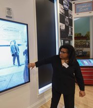 Visitors get a first look and touch of the new interactive displays installed at the Black History Museum Cultural Center of Virginia during a media tour last week. The screens are positioned throughout the museum, which also features a 55-inch touch table.  