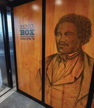 Visitors get a first look and touch of the new interactive displays installed at the Black History Museum Cultural Center of Virginia during a media tour last week. The screens are positioned throughout the museum, which also features a 55-inch touch table.  