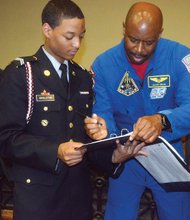 Astronomical Role model //
Engineer Leland Melvin, a retired NASA astronaut from Lynchburg, signs autographs for Franklin Military Academy students during a program April 22 at the East End school marking the 100th anniversary of the Junior Reserve Officers’ Training Corps. During an assembly, Mr. Melvin talked about his role during two missions on the Space Shuttle Atlantis and his experiences as a football player and chemistry major at the University of Richmond. He also earned a master’s degree in materials science engineering from the University of Virginia. The JROTC celebration also featured robotics demonstrations, drone flying and military drills.
