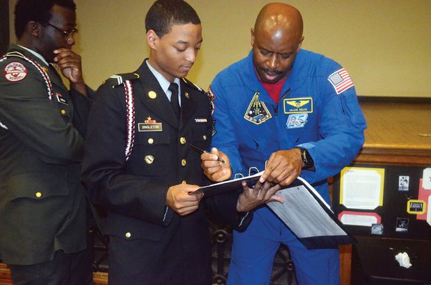 Astronomical Role model //
Engineer Leland Melvin, a retired NASA astronaut from Lynchburg, signs autographs for Franklin Military Academy students during a program April 22 at the East End school marking the 100th anniversary of the Junior Reserve Officers’ Training Corps. During an assembly, Mr. Melvin talked about his role during two missions on the Space Shuttle Atlantis and his experiences as a football player and chemistry major at the University of Richmond. He also earned a master’s degree in materials science engineering from the University of Virginia. The JROTC celebration also featured robotics demonstrations, drone flying and military drills.
