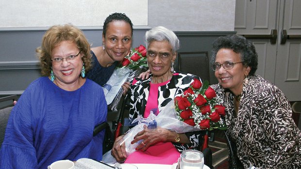 Remembering Richmond’s first black police officers // Lillian Randolph, center, accepts a bouquet of roses Saturday during a dinner commemorating the 70th anniversary of the hiring of the first African-American police officers in Richmond.
Mrs. Randolph’s late husband, Frank S. Randolph, was among the four first officers hired by the city and remembered at the event at a Downtown hotel attended by 150 people.
The other trailblazing officers honored were John W. Vann, Doctor P. Day and Howard T. Braxton. They were hired May 1, 1946.
Richmond Police ChiefAlfred Durham gave the keynote address, while Mayor Dwight C. Jones offered remarks. With Mrs. Randolph are her daughters, Patricia Randolph Myers, left, and Renda Randolph, right.
The event was organized by Richmond Police Sgt. Carol D. Adams, second from left, and sponsored by the Richmond Black Police Officers Association and Engine Company #9.