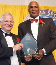 Retired NBA star Charles Oakley is presented with an award last Saturday during his induction into the Virginia Sports Hall of Fame in Portsmouth by Joel Rubin, chairman of the Hall of Fame board.