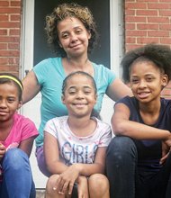 
Tara Spencer sits on the porch of her apartment on Creighton Road with her daughters, from left, Dionicia, 8, La-Taja, 6, and Japria, 12.
