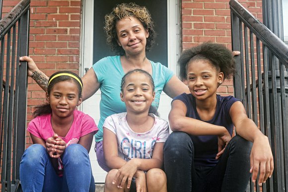 Tara Spencer stands on her porch in the Creighton Court public housing community each school day and watches as her ...