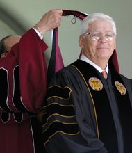 Dr. Perkins hoods businessman and VUU supporter William A. Royall Jr. with an honorary doctorate.