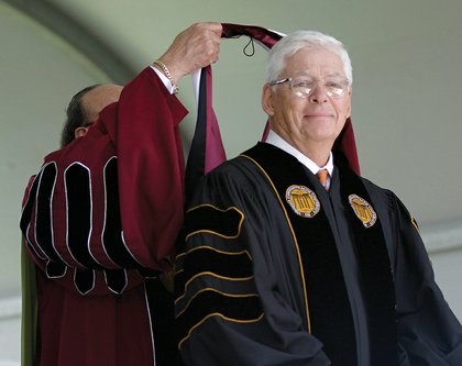 Dr. Perkins hoods businessman and VUU supporter William A. Royall Jr. with an honorary doctorate.