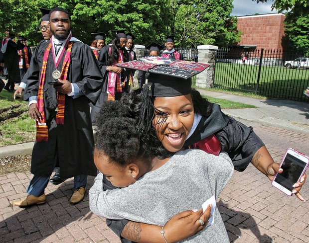 So proud! //
Christine Turner of Chesapeake gets a huge hug of congratulations from her niece, Nijah Roberson, as she and other Virginia Union University candidates for graduation march toward Hovey Field last Saturday for the commencement ceremony. 