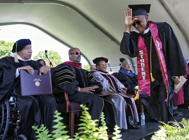 Football star Kevius Morgan happily reacts after receiving his diploma. Looking on, from left, are Dr. Walton Belle, who was awarded an honorary doctorate for his 45 years of service as physician to VUU’s athletic teams; Dr. Frederick D. Hayes III, an activist minister who also received an honorary doctorate; Carolyn W. Jacobs, president  of the VUU National Alumni Association; and commencement speaker Congressman Robert C. “Bobby” Scott. 