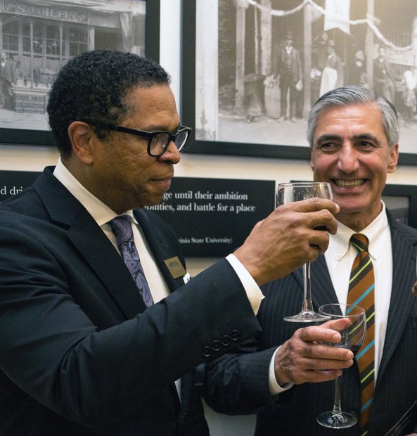 Dr. Monroe E. Harris Jr. and Hossein Sadid, BHM board members, toast to a successful opening. Board Co-chair Bessida Cauthorne White and Chairwoman Marilyn H. West helped lead the multimillion-dollar project. Elijah Crawley, 12, an Elko Middle School student and son of museum director Tasha Chambers, learns firsthand from former Gov. L. Douglas Wilder.
