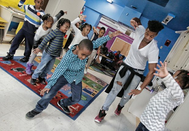 Be a lion //
Mykal Ashlee, a cast member of the popular musical “Disney’s The
Lion King,” teaches dance moves to children at the Child Development Center at Greater Brook Road Baptist Church, 4208 Chamberlayne Ave. He stopped by last Friday to work with children, just two days before the traveling musical ended its run at the Altria Theater on Sunday.