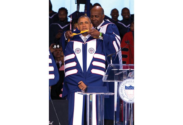 
President Obama is hooded by attorney Vernon E. Jordan, a member of Howard University’s Board of Trustees, as he receives an honorary doctor of laws degree during the Washington institution’s graduation ceremonies last Saturday.