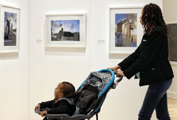 Shenelle Reed strolled with her year- old son, Ka’Leel, who was engrossed in the portraits of Yemaya by Arturo Lindsay