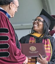 VUU President Claude G. Perkins congratulates valedictorian Veronica Pegram of Mechanicsville, who earned her degree in biology.