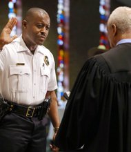 Delrish Moss is sworn in May 9 as the new police chief of Ferguson, Mo., just weeks after a federal judge approved the town’s agreement with the federal Justice Department seeking to resolve racial bias in its criminal justice system. 