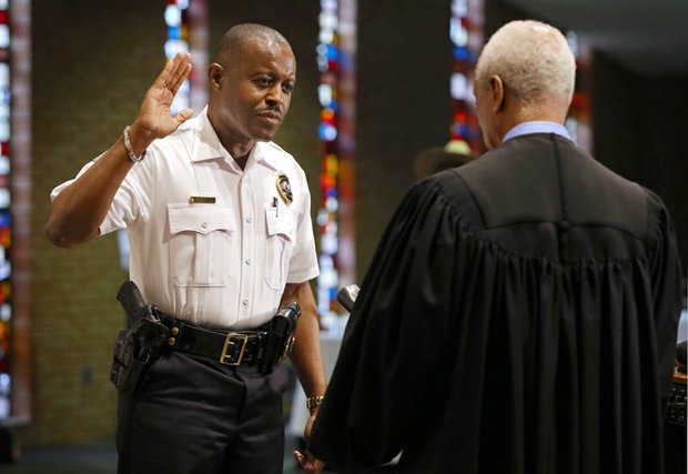 Delrish Moss is sworn in May 9 as the new police chief of Ferguson, Mo., just weeks after a federal judge approved the town’s agreement with the federal Justice Department seeking to resolve racial bias in its criminal justice system. 